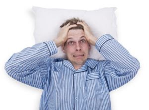 Stressed man in pajama in bed
